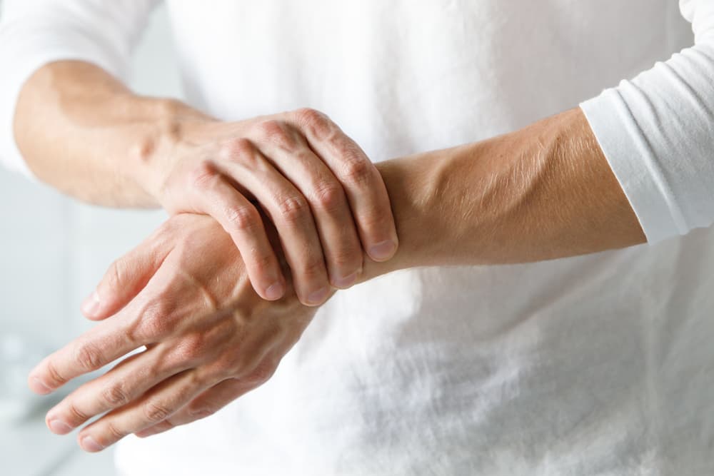 Close-up of a man’s smooth hands and wrists after professional waxing.