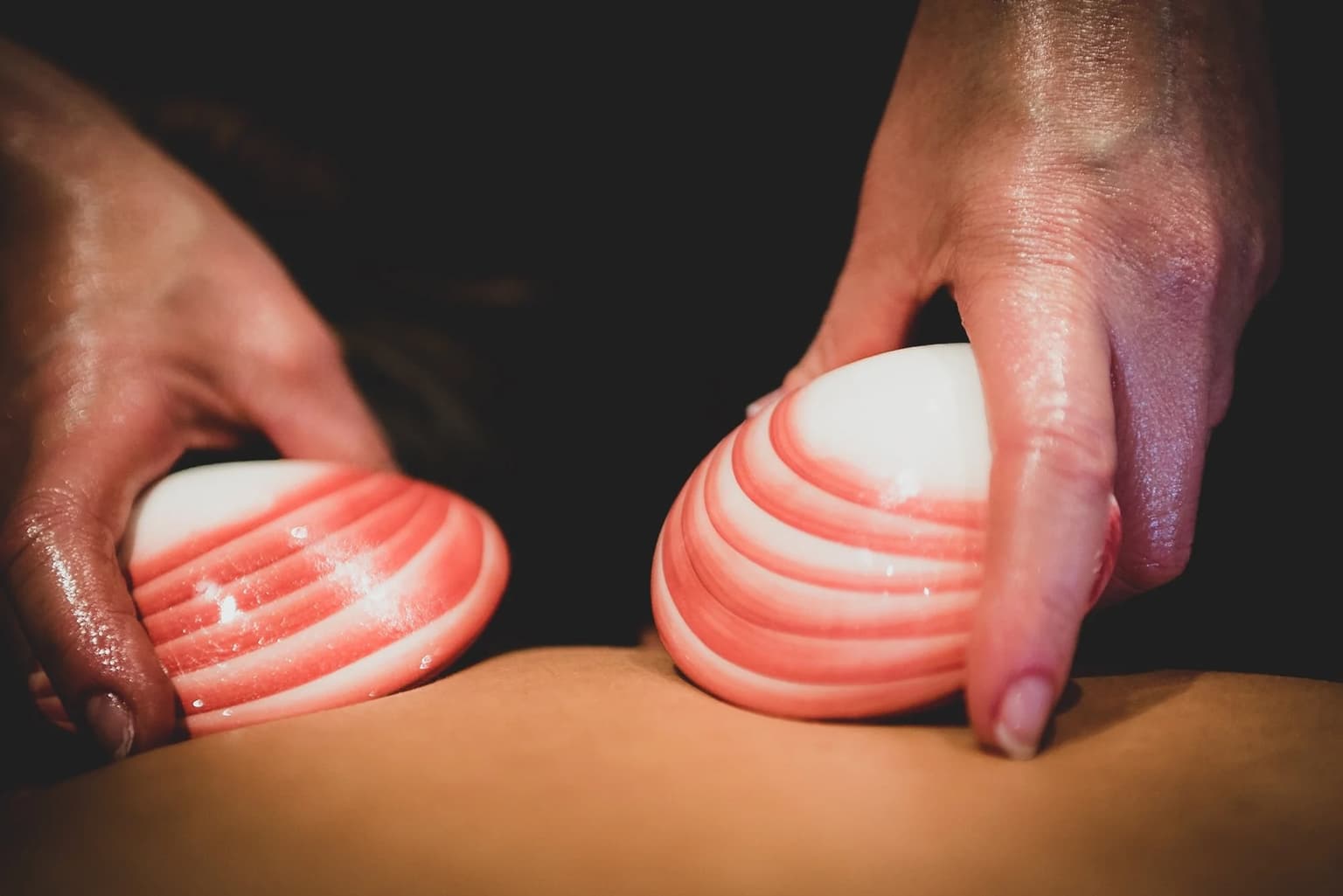 Close-up of therapist using warm lava shells in a full body massage to soothe muscles and enhance relaxation in Weston-super-Mare