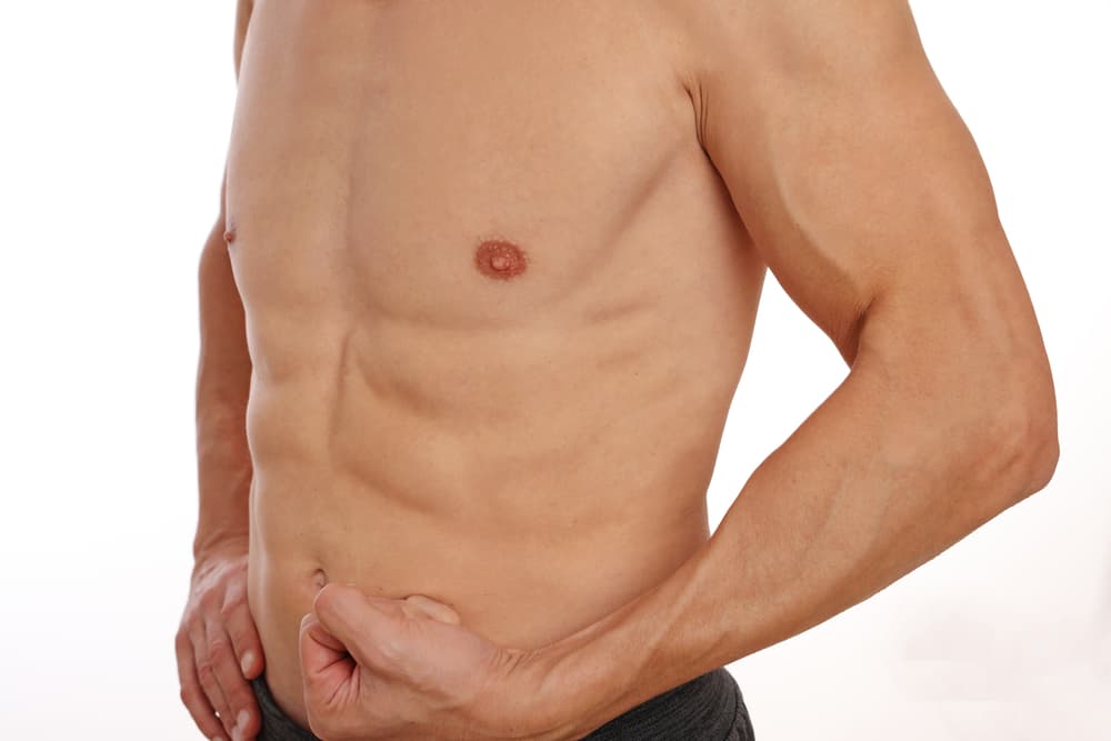 A close-up of a fit man’s smooth chest and arms after a professional full arm wax treatment, showcasing clean and well-groomed skin.