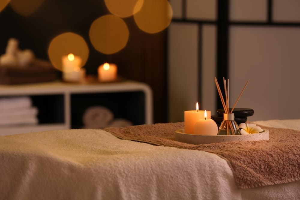 Tranquil massage room with soft lighting, candles, and aromatherapy setup prepared for couples massage tuition in Weston-super-Mare