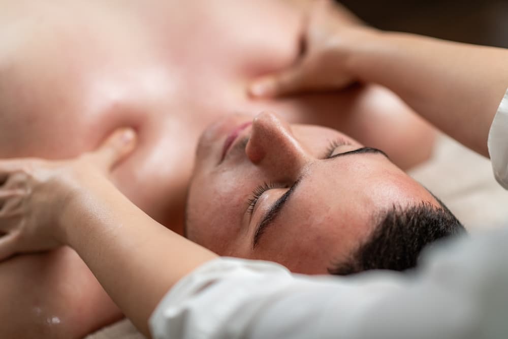 Man receiving an upper body massage with warm oil during a 120-minute sensual massage exchange in Weston-super-Mare