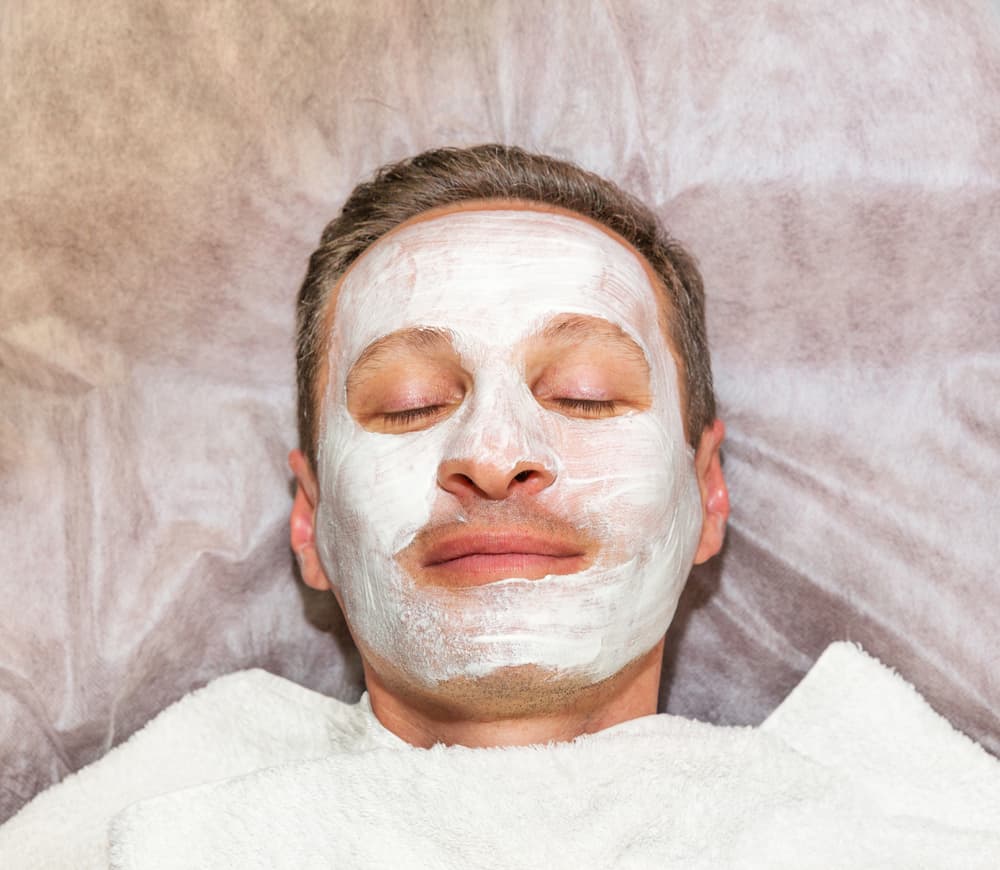 Man relaxing with a full-face balancing facial mask during a Tropic Skincare treatment in Weston-super-Mare