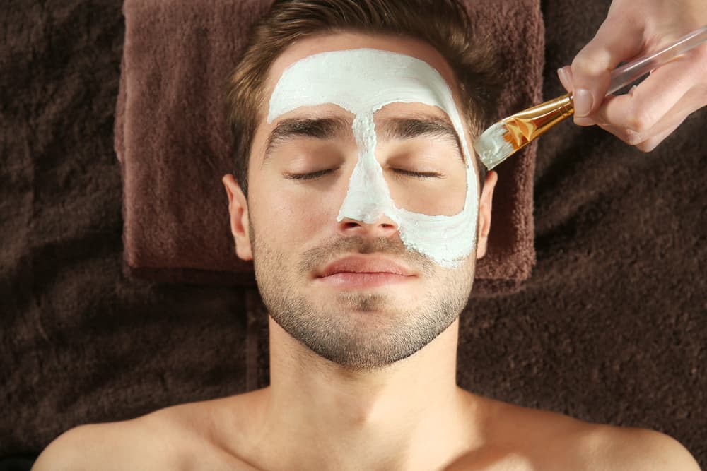 Man enjoying a rejuvenating Tropic facial with cooling mask applied in a private treatment room in Weston-super-Mare